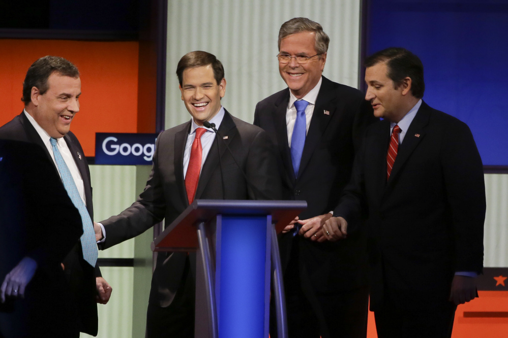 Republican presidential candidates, left to right, New Jersey Gov. Chris Christie, Sen. Marco Rubio, R-Fla., former Florida Gov. Jeb Bush and Sen. Ted Cruz, R-Texas, talk after the Republican presidential primary debate Thursday in Des Moines, Iowa.