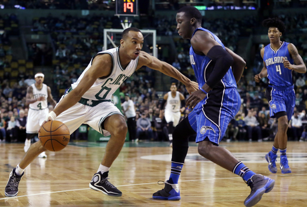 Celtics guard Avery Bradley drives against Orlando’s Tobias Harris in the first quarter Friday night in Boston.