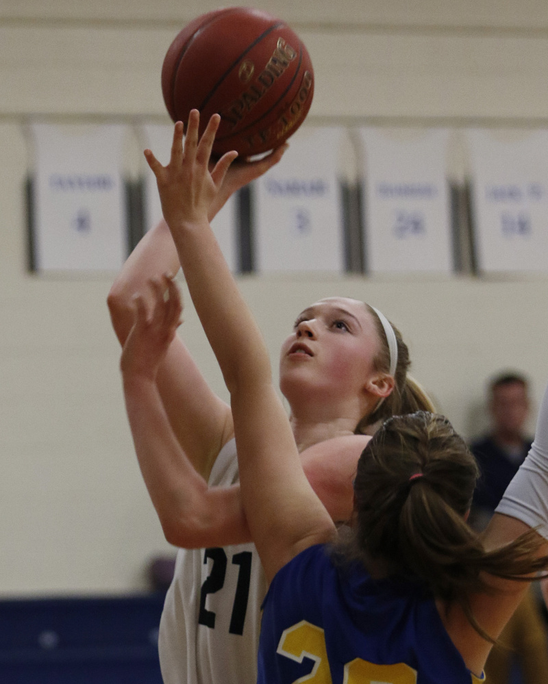 Yarmouth’s Alison Clark, left, goes up for a shot against Abby Ryan of Falmouth during their girls’ basketball game Friday in Yarmouth. Clark led the Clippers to a 48-25 victory.  Joel Page/Staff Photographer