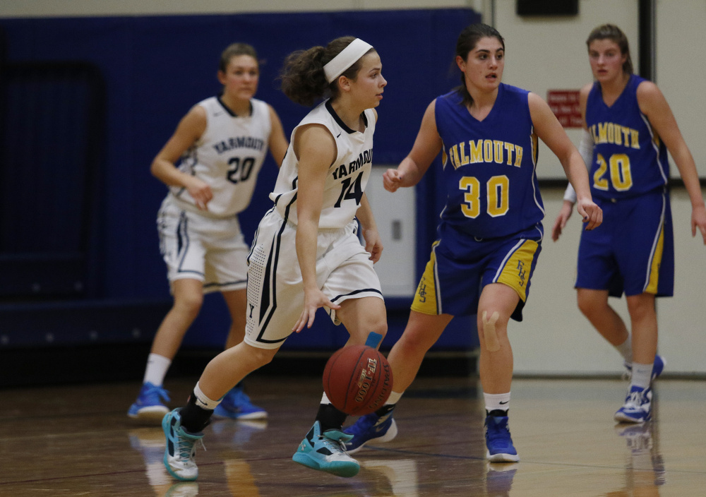 Jessica Kirk of Yarmouth looks for a teammate while being guarded by Falmouth’s Adelaide Cooke. Yarmouth used a 20-0 run in the second and third quarters to pull away for a 48-25 win.
Joel Page/Staff Photographer