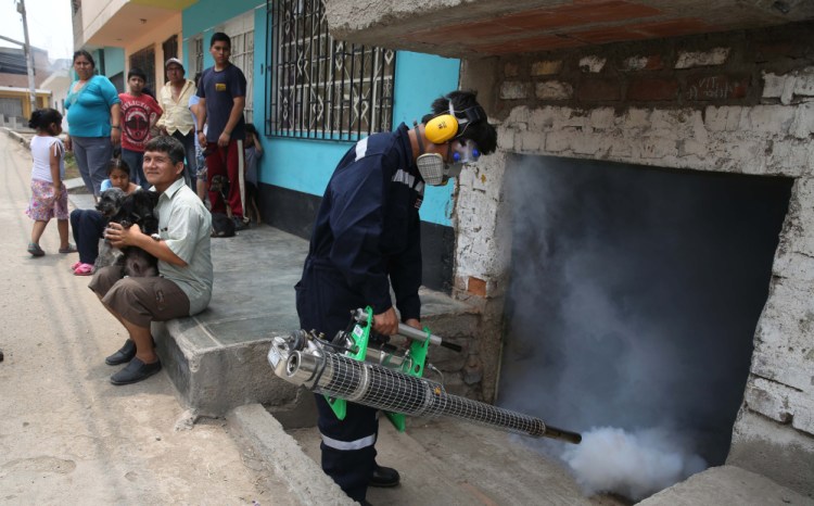 A health worker in Lima, Peru, fumigates on Friday against the mosquito that carries the Zika virus. Though it causes only a mild illness in most people, some reports link it to a birth defect with a smaller head size.