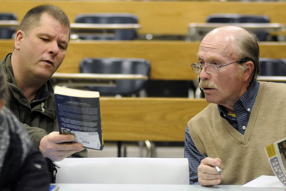 George Van Deventer, right, confers with classmate Roland Choate during a U.S. history class at the University of Maine at Augusta.