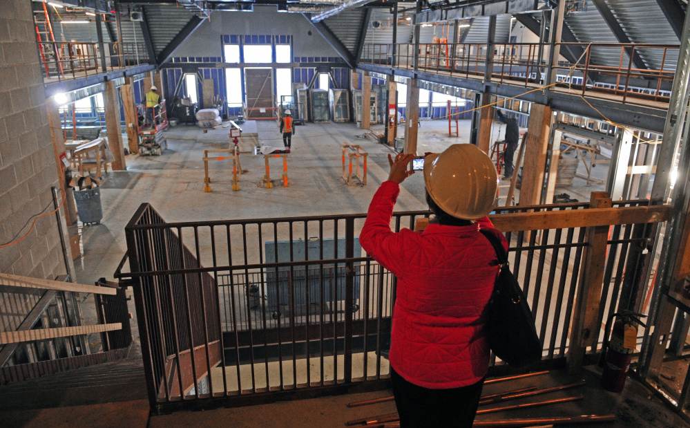 Library Director Betsy Pohl photographs the work underway during a tour of the Lithgow Public Library in Augusta.