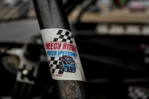 A faded sticker clings to the roll cage of a stock car before a race on NASCAR Nite at Beech Ridge Motor Speedway in Scarborough last summer. The speedway’s owner was the victim of a brutal attack at his home in 2014.