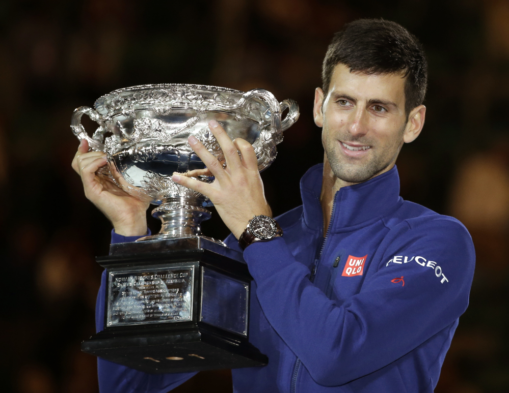 Novak Djokovic holds his trophy after defeating Andy Murray in the men’s singles final at the Australian Open on Sunday in Melbourne.