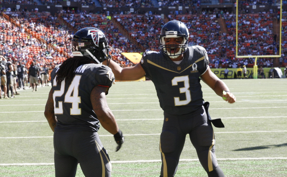 Atlanta Falcons running back Devonta Freeman, left, and Seattle Seahawks quarterback Russell Wilson of Team Irvin celebrate after Freeman scored a touchdown during the first quarter of the Pro Bowl Sunday in Honolulu.