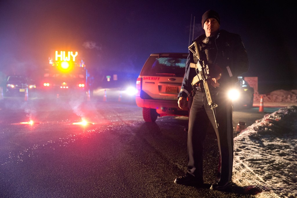 Sgt. Tom Hutchison stands in front of an Oregon State Police roadblock on Highway 395 on Tuesday night between John Day and Burns, Ore. The FBI arrested the leaders of an armed group that has occupied a federal wildlife refuge in eastern Oregon for the past three weeks.
Dave Killen/The Oregonian via AP