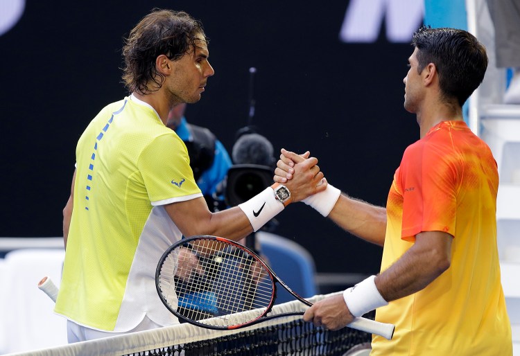 Rafael Nadal, left, of Spain congratulates compatriot Fernando Verdasco after their first round match at the Australian Open tennis championships in Melbourne, Australia, Tuesday. The Associated Press