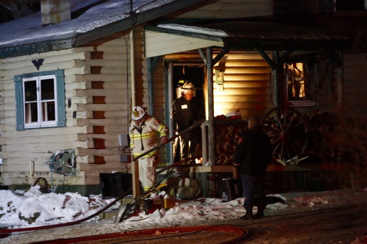 Firefighters leave the residence at 8 Bear Run Road where a fire claimed the life of Barry Dunlap, 55, Sunday night. Derek Davis/Staff Photographer