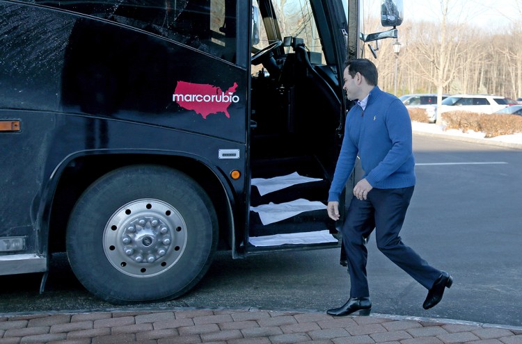 Republican presidential candidate Sen. Marco Rubio, R-Fla., gets on his bus after a campaign stop Sunday in Atkinson, N.H. The Associated Press