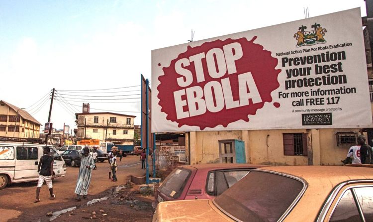 A banner reading 'STOP EBOLA' forms part of Sierra Leone's Ebola-free campaign in the city of Freetown. The Associated Press