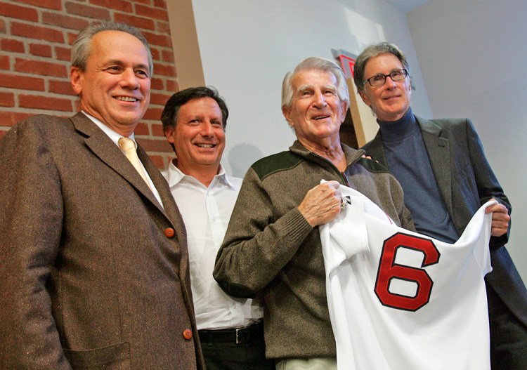 Former Boston Red Sox player Johnny Pesky holds a No. 6  jersey, along with Red Sox owners John Henry, right, and Tom Werner, second from left, and then-president/CEO of the Red Sox Larry Lucchino, left, during a news conference on Sept. 23, 2008, to announce that the team would retire Pesky's number on the eve of his 89th birthday. The Associated Press