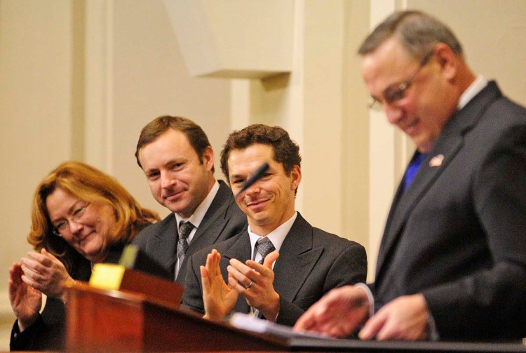 Leigh Saufley, chief justice of the Maine Supreme Judicial Court, left, Speaker of the House Mark Eves, and then-Senate President Justin Alfond applaud during Gov. Paul LePage's State of the State address on Feb. 5, 2013. This year, LePage says, he's "probably gonna go back to the 1800s and do it by letter."
Joe Phelan / Kennebec Journal