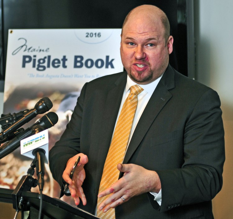 Matthew Gagnon of the Maine Heritage Policy Center talks about the 2016 Maine Piglet Book during a news conference Thursday at the State House Welcome Center in Augusta. In a news release, the policy center said that the booklet “highlights the rampant and appalling examples of the abuse of taxpayer dollars that big government doesn’t want you to know about.”