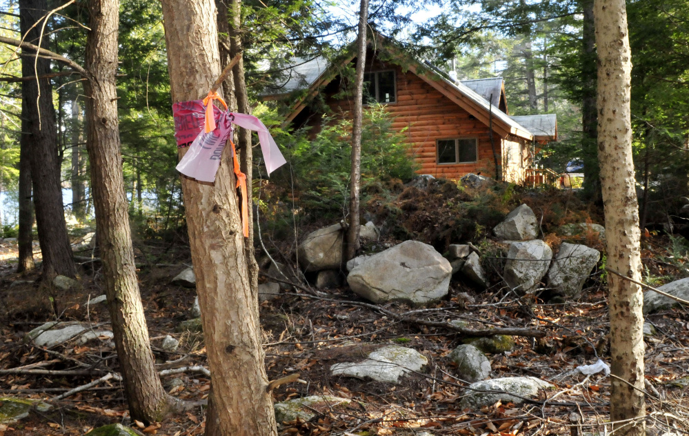 A ribbon marks the boundary of a proposed summer camp and the Jorgenson property on Long Pond in Rome. Doris and Eric Jorgenson, as well as other nearby residents, have filed an appeal of the building permit for the camp approved by the Planning Board.
