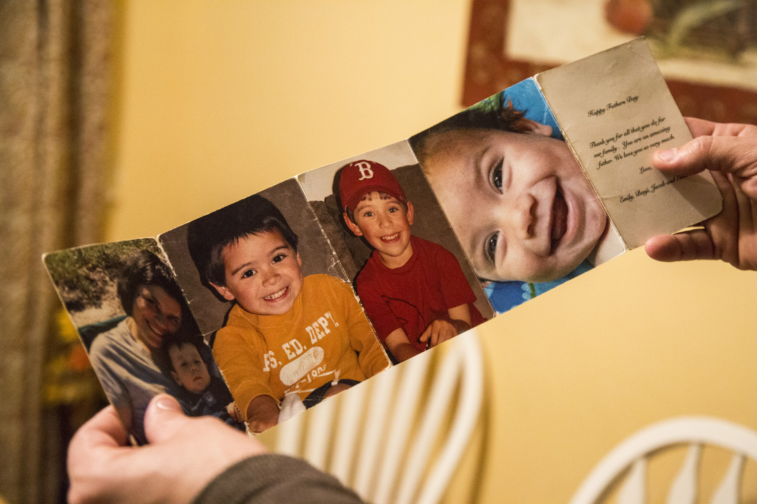 Mark Tidd holds up one of his favorite Father's Day gifts, a folded display of photos of his children, including his daughter Lucy Tidd, in the red baseball cap, in Portland.