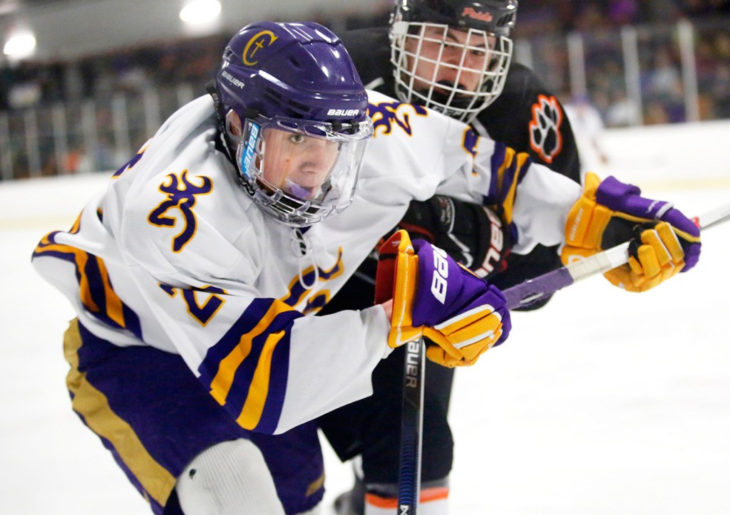 Ryan McSorely of Cheverus fights for the puck with Brady Crepeau of Biddeford during the third period of Monday's Class A South quarterfinal game. Cheverus came from behind to win in overtime, 6-5. Scarborough is the No. 1 seed in the Class A South playoffs, while Cheverus is seeded fourth.