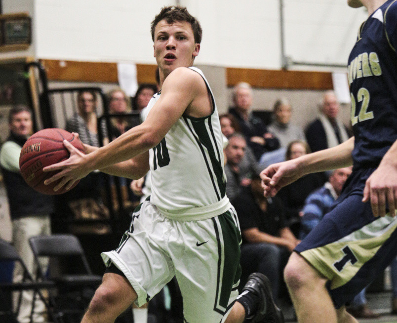 Willy Burdick of Waynflete looks to penetrate Monday while defended by Shane MacNeill of Traip Academy during Waynflete’s 48-47 victory at home. The Flyers improved to 15-2 and dropped Traip to 5-12.