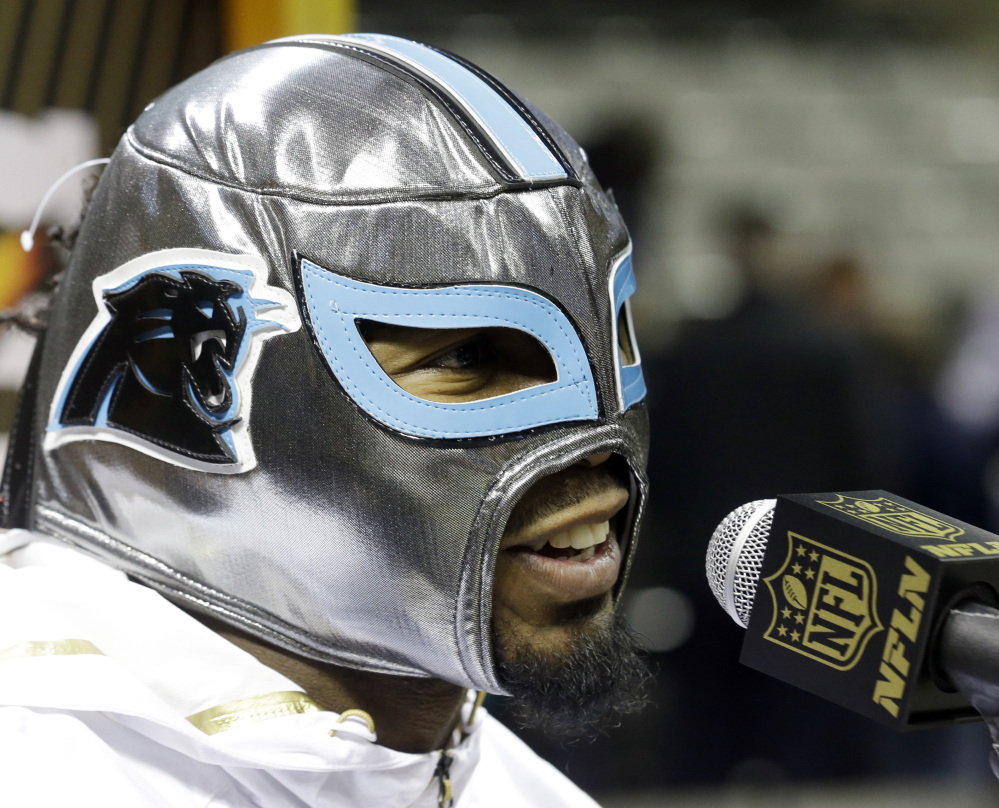 Josh Norman of the Carolina Panthers wears a mask while answering a question during the NFL’s Super Bowl Opening Night on Monday. Yes, they’ll be there all week.