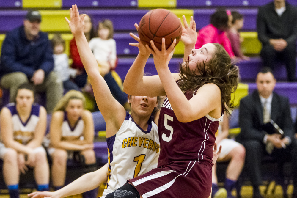 Mackenzie Holmes, the freshman center who’s so hard to stop for Gorham, drives against Alayna Briggs of Cheverus. Holmes collected 20 points in a 64-36 victory on the road.