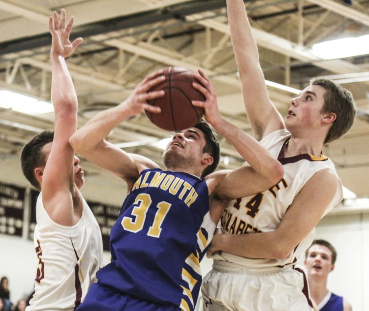Marshall Peterson, left, and Matt Graham of Cape Elizabeth surround Sam Skop of Falmouth as he tries to get a shot off Tuesday night. Falmouth, ranked No. 1 in Class A South, beat the Capers for the second time, 44-42.