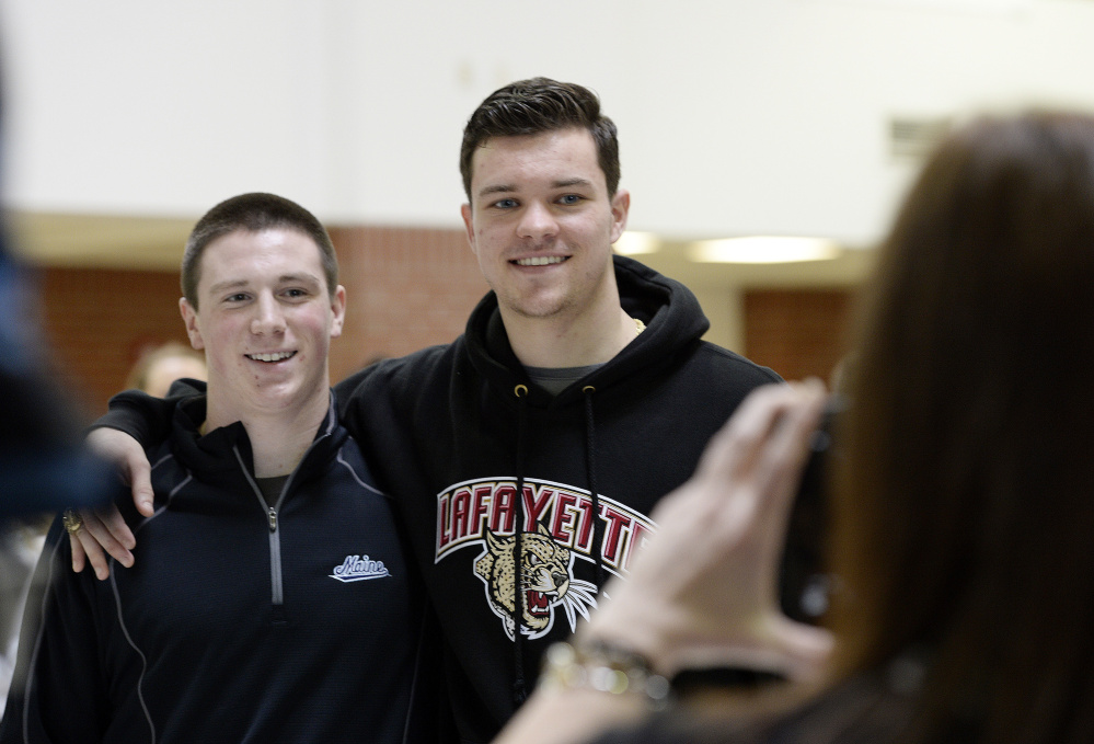 Thornton Academy football players Owen Elliott and Austin McCrum pose for photographs Wednesday after signing National Letters of Intent to play NCAA Division I football. Elliott is going to UMaine and McCrum will attend Lafayette.
Shawn Patrick Ouellette/Staff Photographer
