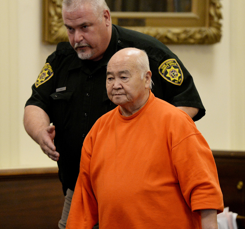 James Pak is lead into York County Superior Court in Alfred Wednesday, when he pleaded guilty of fatally shooting two teenagers and wounding a woman in a tenant dispute in 2012.