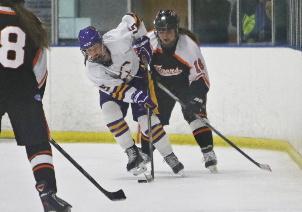 Caitlin Wolff of Cheverus/Kennebunk/Old Orchard Beach looks for room to skate Wednesday as Calea Roy of Biddeford approaches during the second period of Cheverus/Kennebunk/Old Orchard Beach’s 5-3 victory.