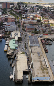 The 7-acre Maine State Pier includes the blue Portland Ocean Terminal building, seen from above at right. At upper left are the Casco Bay Lines ferry terminal and garage.