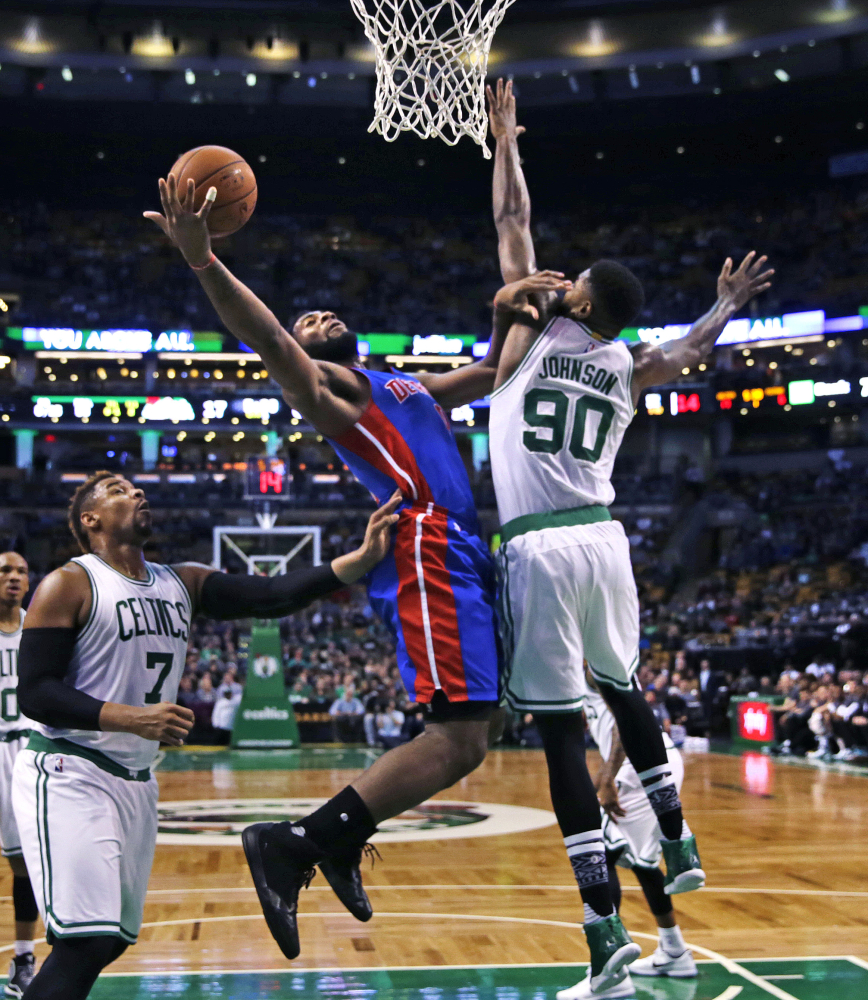 Johnson tries to block Detroit Pistons center Andre Drummond on a drive to the basket during the first quarter.