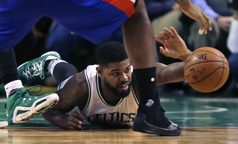 Boston Celtics forward Amir Johnson (90) dives for a loose ball during the second quarter of an NBA basketball game against the Detroit Pistons in Boston on Wednesday. Photos by The Associated Press
