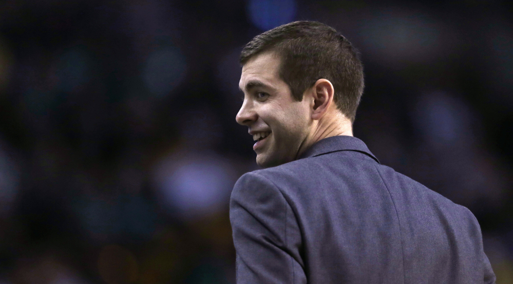 Boston Celtics head coach Brad Stevens smiles as he heads back to the bench during the first quarter.