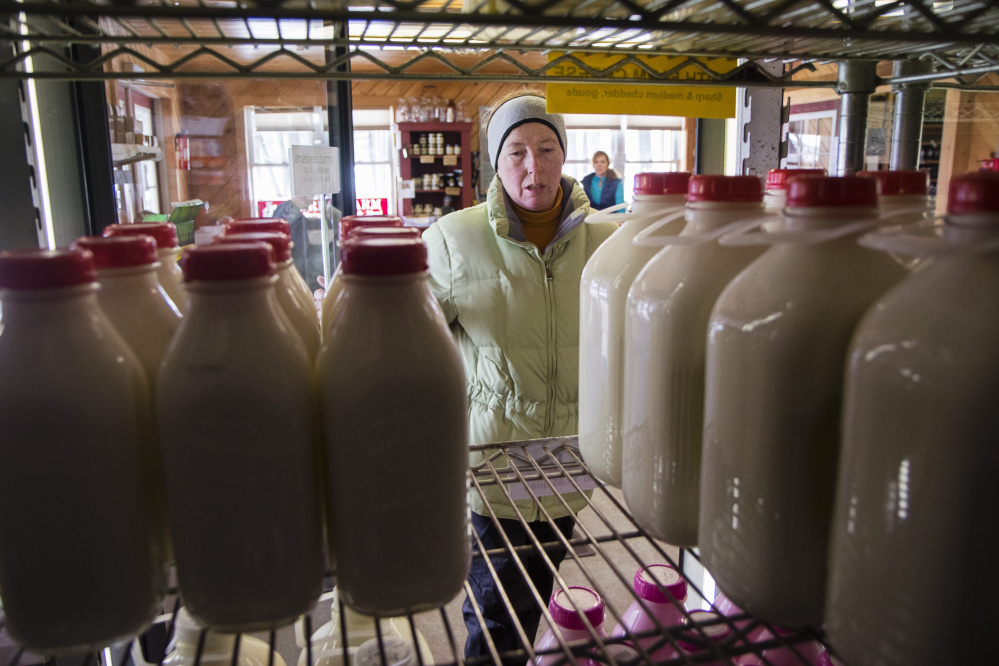 Pauline Morin of Dayton picks her flavor of milk in the cooler at Harris Farm in Dayton.