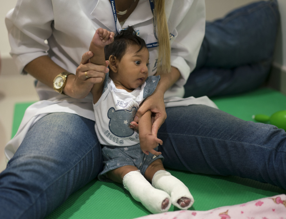 A therapist works with a microcephaly patient at a treatment center in Recife, Brazil, on Thursday. Brazilian authorities say they have detected a spike in the cases of small heads in newborns, but a link between Zika virus and microcephaly is as yet unproven.