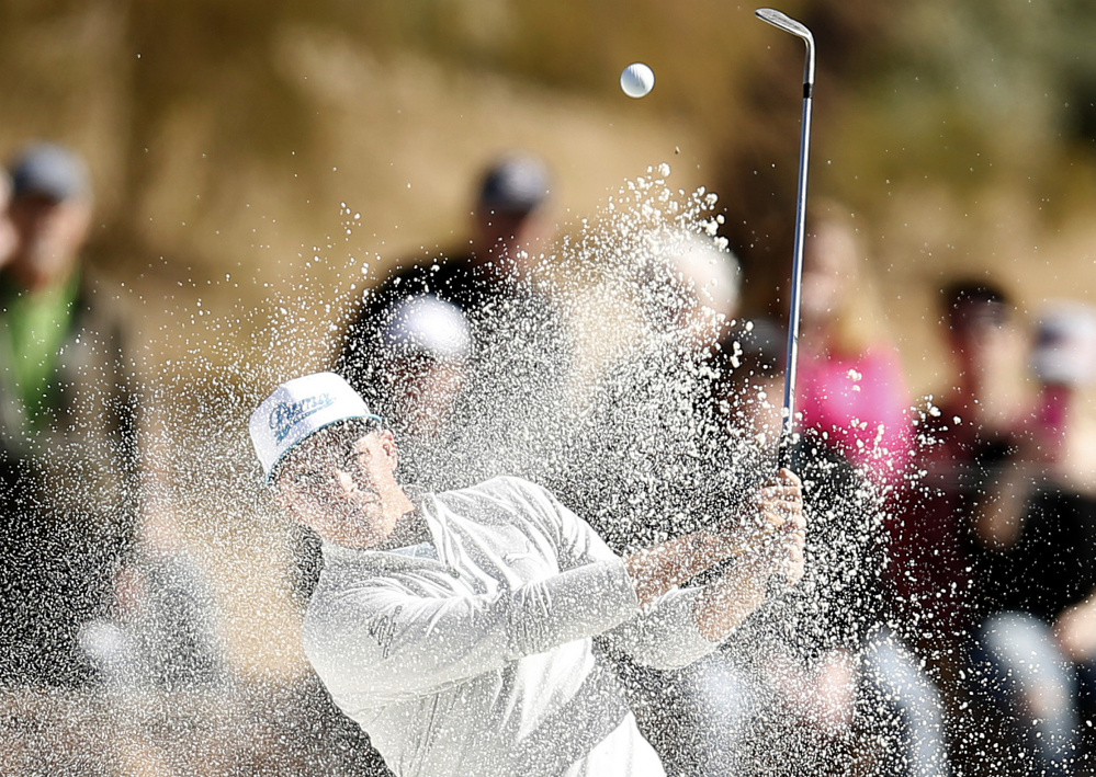 Rickie Fowler blasts out of trap during the first round of the Phoenix Open on Thursday at Scottsdale, Arizona. A frosty morning led to play being suspended with Fowler, Shane Lowry and Hideki Matsuyama sharing the lead for the day.