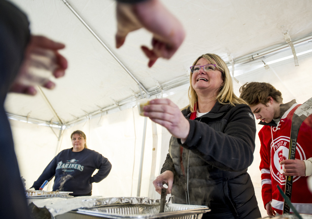 Allison Stailing hands out samples of her corn chowder at the chili-chowder challenge in South Portland last Saturday.