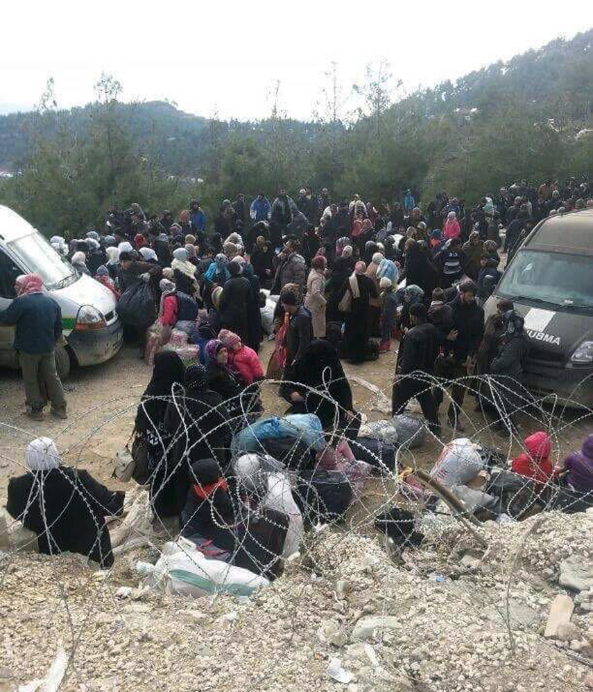 Syrians wait to enter Turkey at the Bab al-Salam border gate. The Associated Press