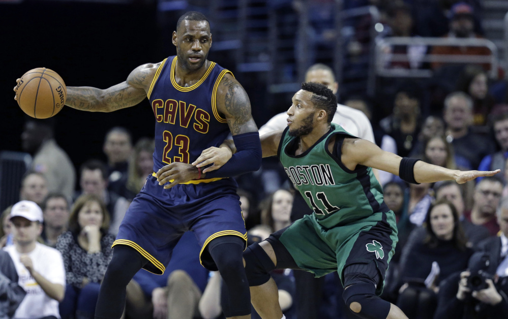 Cleveland’s LeBron James backs down Boston’s Evan Turner in the first half of the Celtics’ 104-103 win Friday in Cleveland.