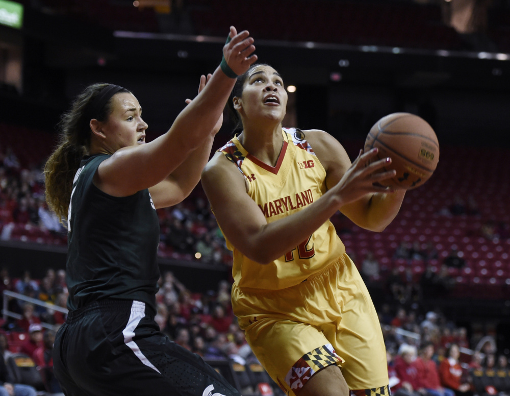 Maryland’s Brionna Jones drives to the basket Friday night against Jasmine Hines of Michigan State. Jones had 17 points and 17 rebounds in an 85-76 victory.