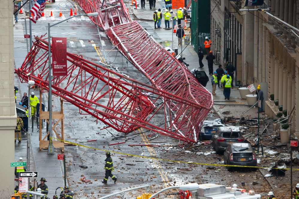 A collapsed crane fills the street on Friday in New York. The huge construction crane was being lowered to safety in a snow squall when it plummeted onto the street in the Tribeca neighborhood of lower Manhattan.