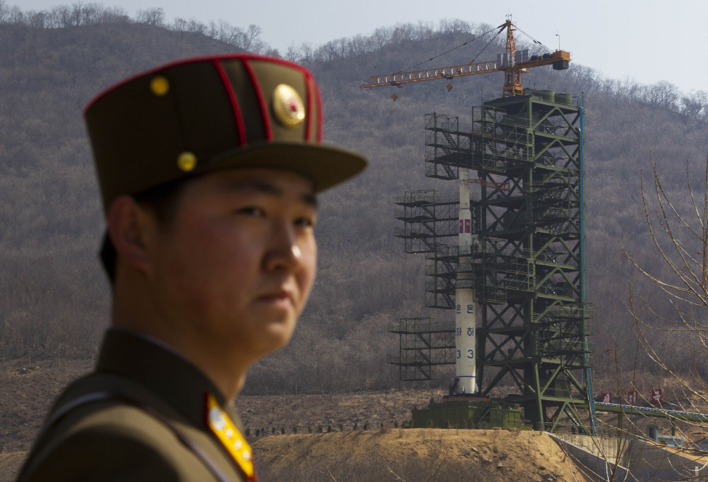 A North Korean soldier stands in front of the rocket launching site in Tongchang-ri.