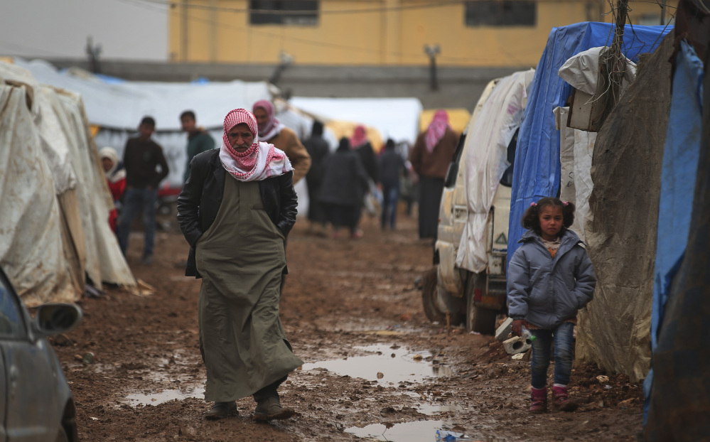 Although Turkey is providing aid to thousands of displaced Syrians, such as these near the Bab al-Salam border crossing in Syria, it has yet to open its gates to more refugees.