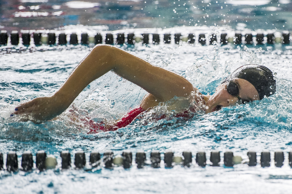 Freshman Olivia Tighe of Cape Elizabeth takes a breath while on her way to winning the 200-yard freestyle. Tighe was named the top performer of the meet while leading the Capers to the team title. Only Cape Elizabeth and Greely have won the championship since 2008.