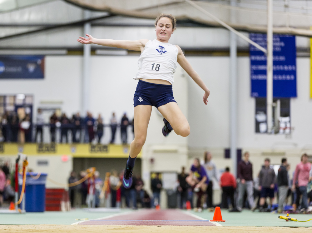 Kelsey Cavanaugh of Westbrook soars toward the long jump pit Saturday during the SMAA indoor track and field championships at the University of Southern Maine. Cavanaugh placed second with a jump of 15-1 .