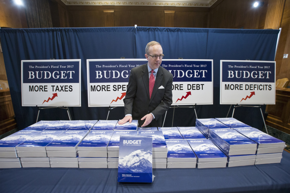 Copies of President Barack Obama’s final fiscal 2017 federal budget proposal are staged for display by Eric Euland, Republican staff director for the Senate Budget Committee, Tuesday on Capitol Hill.