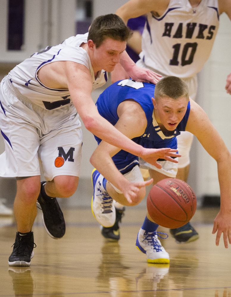 Ben Beers of Marshwood and Kennebunk freshman Cameron Lovejoy compete for a loose ball Tuesday night. Marshwood won and will meet top-ranked Greely in the quarterfinals Friday night at the Portland Expo.

Carl D. Walsh/Staff Photographer