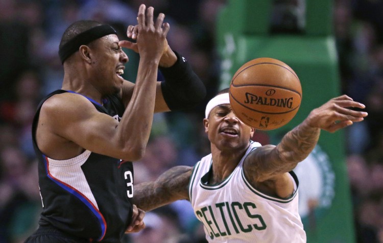 Celtics guard Isaiah Thomas knocks away a pass to Clippers forward Paul Pierce in the first quarter of what turned out to be a long, high-scoring win for the Celtics.