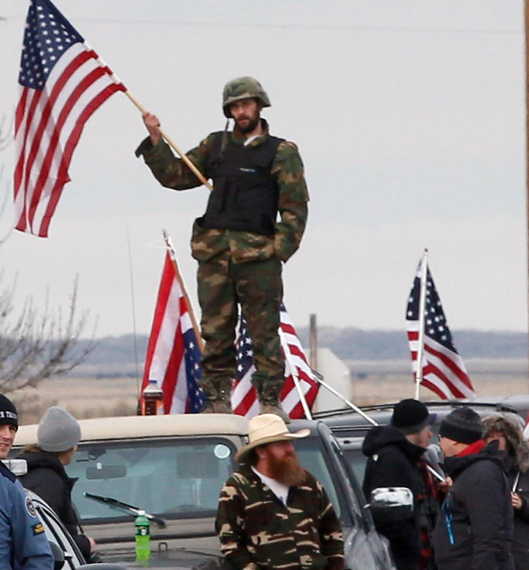 Authorities and demonstrators wait at the Narrows roadblock near the Malheur National Wildlife Refuge, Thursday, Feb. 11, 2016, near Burns, Ore. The last four occupiers of a national wildlife refuge in eastern Oregon surrendered Thursday. The holdouts were the last remnants of a larger group that seized the wildlife refuge nearly six weeks ago, demanding that the government turn over the land to locals and release two ranchers imprisoned for setting fires. (Thomas Boyd/The Oregonian via AP) MAGS OUT; TV OUT; NO LOCAL INTERNET; THE MERCURY OUT; WILLAMETTE WEEK OUT; PAMPLIN MEDIA GROUP OUT; MANDATORY CREDIT