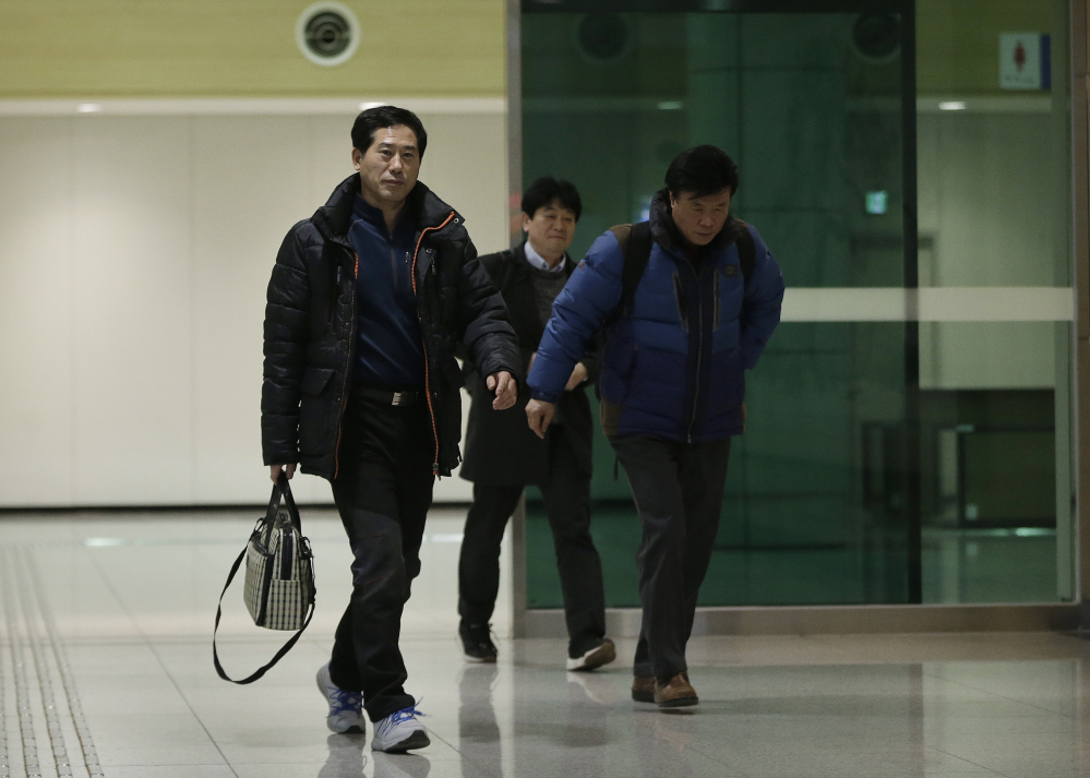 The Associated Press
South Korean businessmen return from North Korea’s Kaesong Industrial Complex at the customs, immigration and quarantine office near the border village of Panmunjom, in Paju, South Korea, on Thursday. North Korea on Thursday ordered a military takeover of a factory park that had been the last major symbol of cooperation with South Korea, calling Seoul’s earlier suspension of operations at the jointly run facility as punishment for the North’s recent rocket launch a “dangerous declaration of war.”