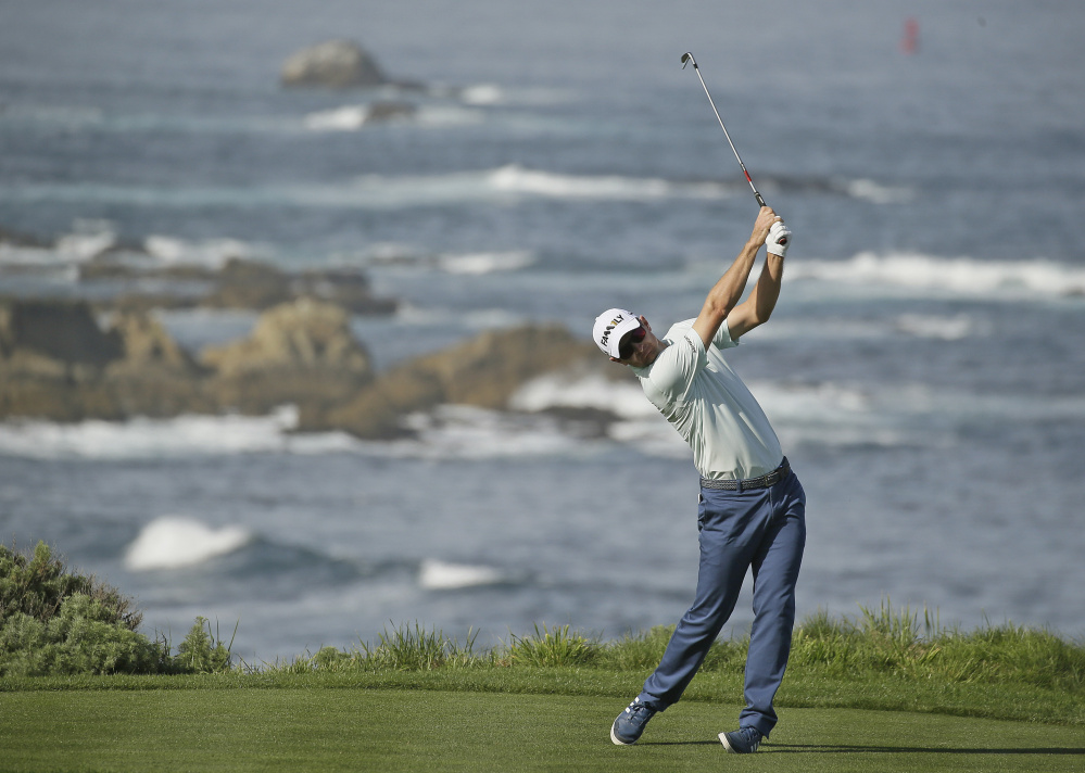 Justin Rose follows his shot from the fourth tee at Spyglass Hill during the first round of the AT&T Pebble Beach National Pro-Am tournament on Thursday in Pebble Beach, California. Rose shot a 6-under 66.